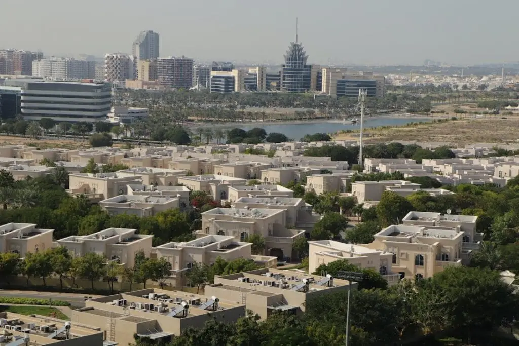 Aerial view of Dubai residential neighbourhood with high-rise skyline in the background — ideal for holiday home investment